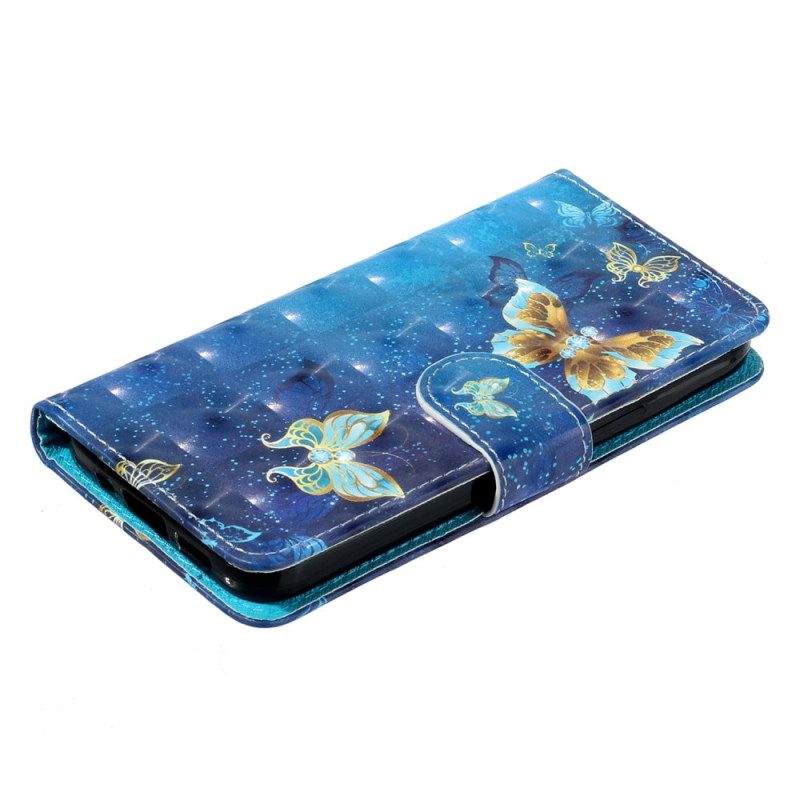 Fodral För Samsung Galaxy S25 Fe Blå Och Guldfärgade Fjärilar Med Snodd